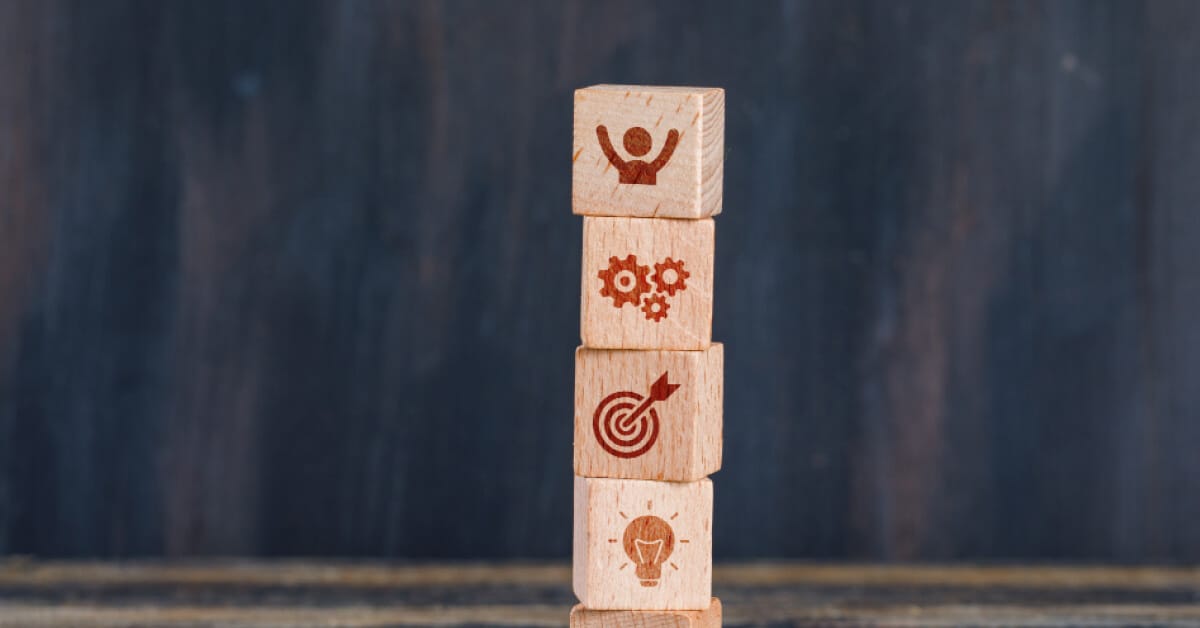 Wooden blocks that symbolizes idea, targets, system, and win