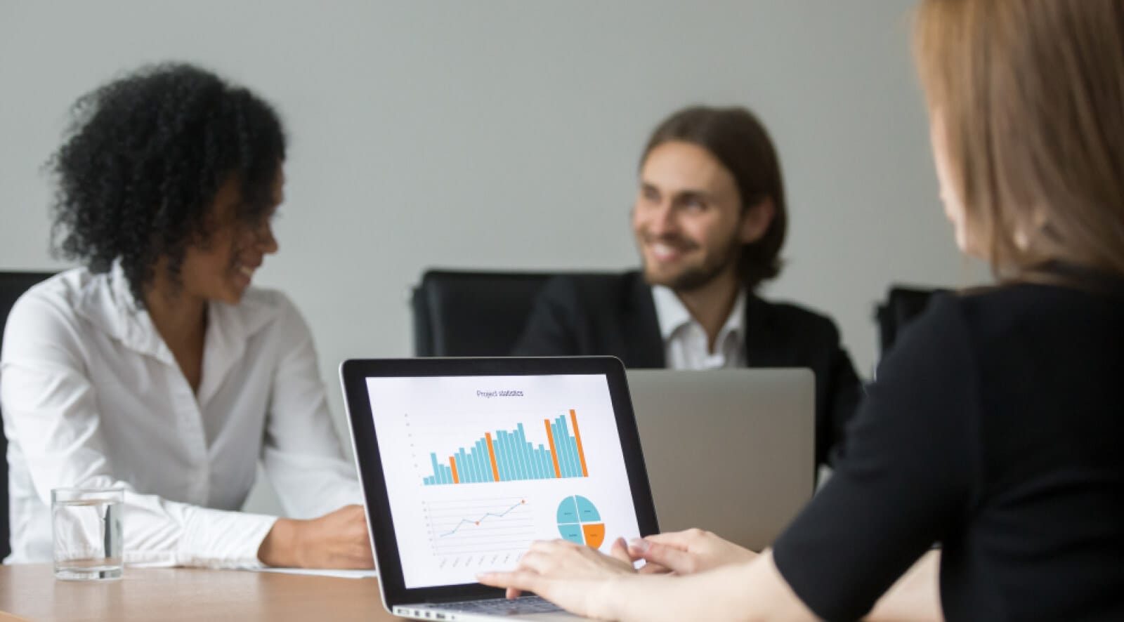 An office desk with, coworkers around